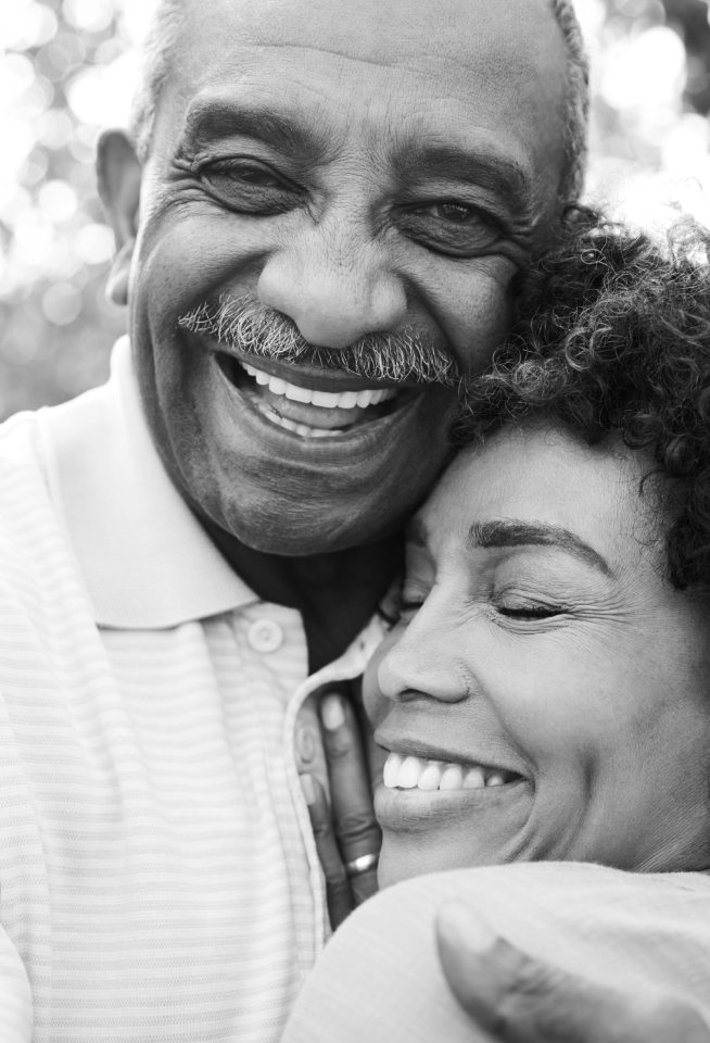 Couple hugging and smiling.